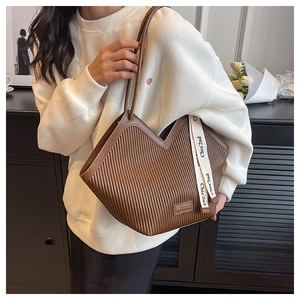 Vue détaillée du sac cabas marron avec texture plissée verticale et coupe en V en haut