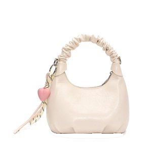 Minimalist beige hobo bag with scrunchie handle and heart pendant on white background