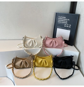 Macro detail of the cloud pleated crescent bag in five colors showing lychee texture