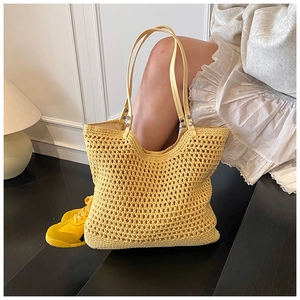 Close-up of the yellow woven knit texture and PU shoulder strap on the summer tote bag