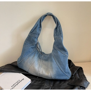 Close-up of vintage denim hobo bag showing blue and white patchwork texture and detail