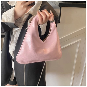 Close-up of pink ruched hobo bag with silver metallic bead handle and chain detail