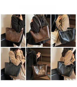 Close-up of vintage textured leather tote bag showing drape and capacity on models