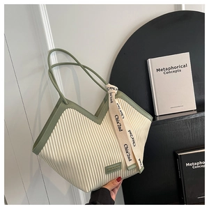 Vue détaillée du sac cabas plissé vertical avec bordure vert foncé et sangle décorative