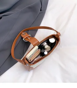 Internal view showing large storage capacity for phone and wallet in contrast shoulder bag