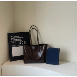 Close-up of the large oil-wax leather tote bag in dark brown with dual shoulder straps