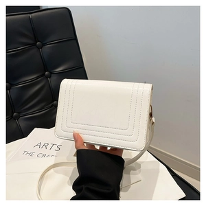 Minimalist white leather square bag with layered embossing and a thin shoulder strap
