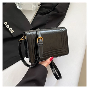 Fashionable black textured leather crossbody bag with flap and gold hardware detail