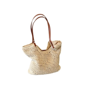 Fashionable hollow woven shoulder bag with brown leather straps for beach vacations