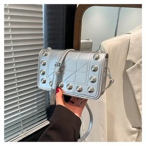 Chic silver metallic crossbody bag with stylish rivet studs and adjustable shoulder strap