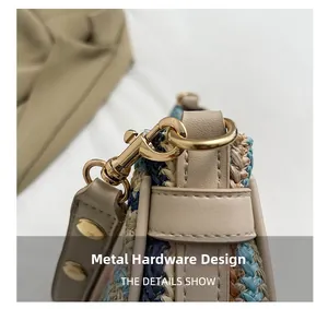Detailed close-up of golden metal hooks and woven straw texture on the handbag