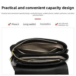 Top view of black multi-compartment interior with gold zipper and leather texture