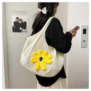 Detail of crochet tote bag with large yellow flower detail for women casual style