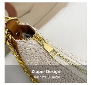 Detail of gold metal zipper and woven texture on a minimalist contrast shoulder bag