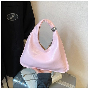 Borsa a mano rosa con forma curva e dettaglio moderno di una sfera in metallo argento