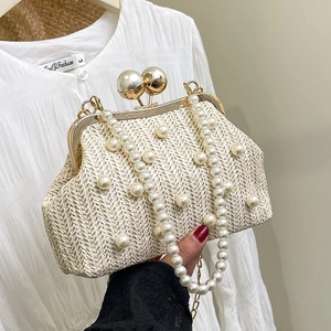 Elegant woven straw bag with pearl embellishments and a decorative pearl strap