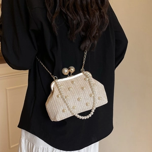 Straw weave handbag with white pearl embellishments and gold metal clasp in beige tone