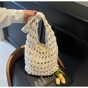 Detail of hollow woven cotton handbag with a drawstring liner and bohemian style