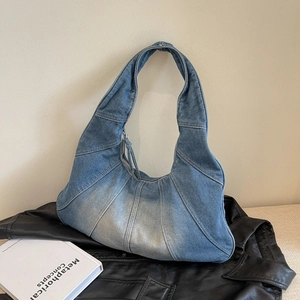 Retro patchwork denim crescent bag with washed gradient and silver zipper closure