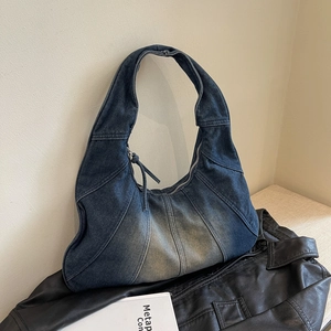 Retro patchwork denim hobo bag with vintage wash and long tassel zipper on leather jacket