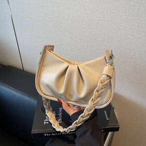 Chic beige pleated crescent shoulder bag with a woven handle and pebble leather texture