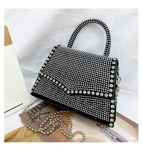 Close-up of black rhinestone handbag featuring silver beaded chain and sparkling crystals
