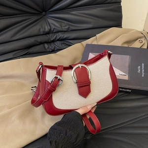 Minimalist red leather and canvas patchwork crossbody bag with silver buckle and strap
