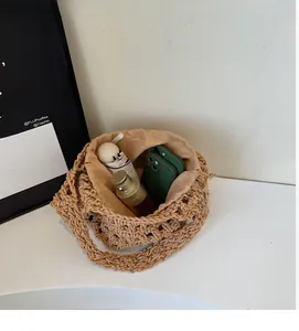 Detailed interior of a beige crochet bucket bag showing large capacity for daily items