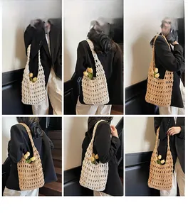 Detail view of woven hollow tote bag with wide straps in beige and light brown