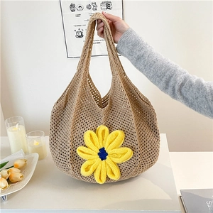 Minimalist straw tote bag with yellow crochet flower and openwork mesh design