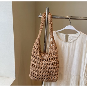 Detail of khaki hollow mesh woven tote bag with matching drawstring inner lining pouch