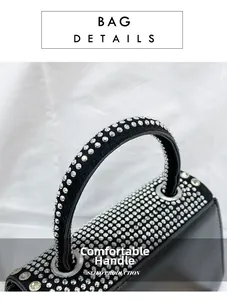 Close-up of luxury black handbag handle encrusted with silver rhinestones and chain detail