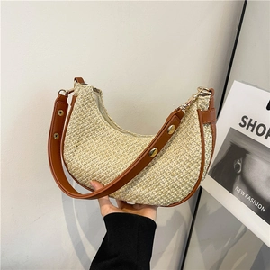 Minimalist straw crescent shoulder bag with brown leather trim and golden metal buckle