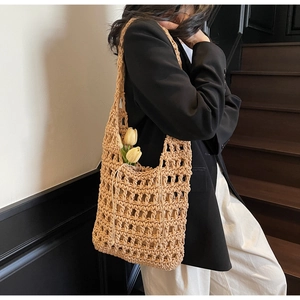 Detailed texture of handmade hollow crochet tote bag with matching drawstring inner pouch