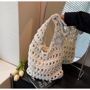 Detail view of woven hollow net bag with a beige drawstring inner liner for privacy