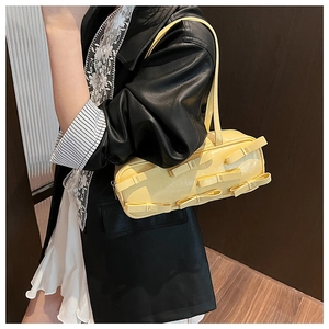 Close-up of yellow shoulder bag featuring multiple 3D bows and glossy faux leather texture