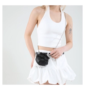 Detail of black mini round bag with bow decoration and silver bead chain strap