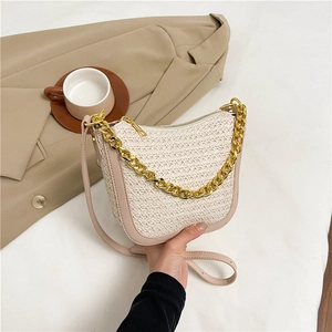 Minimalist woven handbag with gold chain strap and brown leather trim in cream white