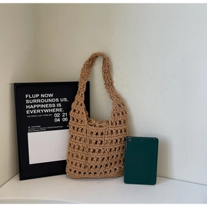 Detail of hollow hand-woven tote bag with drawstring inner pouch and minimalist texture