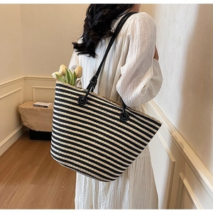 Minimalist black and white striped woven tote bag with large capacity and dual shoulder straps