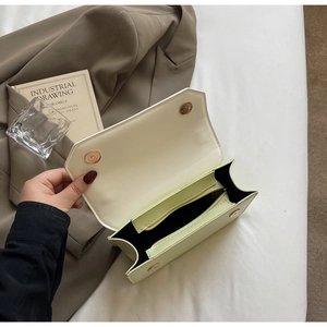 Vue intérieure du sac à bandoulière vert clair montrant les compartiments et le fermoir