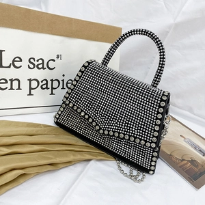 Chic rhinestone crossbody bag with silver ball chain on a stylish white background