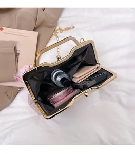 Interior view showing the large capacity of this elegant pink clutch bag with metal frame