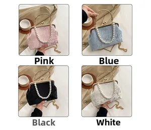 Detail view of pearl chain straps and embossed floral jacquard texture on vintage handbags