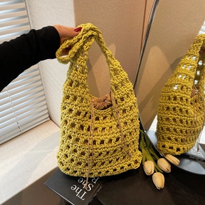 Handmade yellow hollow crochet tote bag with drawstring inner pouch and wide shoulder strap