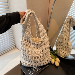Chic hollow hand-woven shoulder bag with drawstring pouch in cozy lifestyle setting