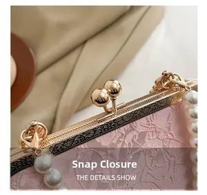 Detail of vintage pink jacquard handbag featuring a gold floral clasp and pearl handle