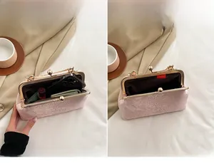Pink vintage brocade kiss-lock clutch interior showing space for phone and makeup