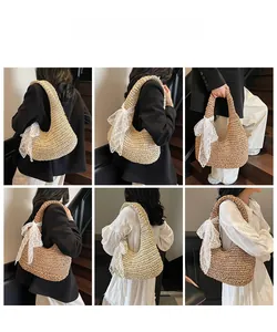 Detail of hand-woven straw hobo bag featuring a decorative white lace bow and texture
