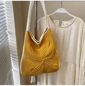 Detail of yellow hollowed-out crochet shoulder bag with intricate star weave pattern